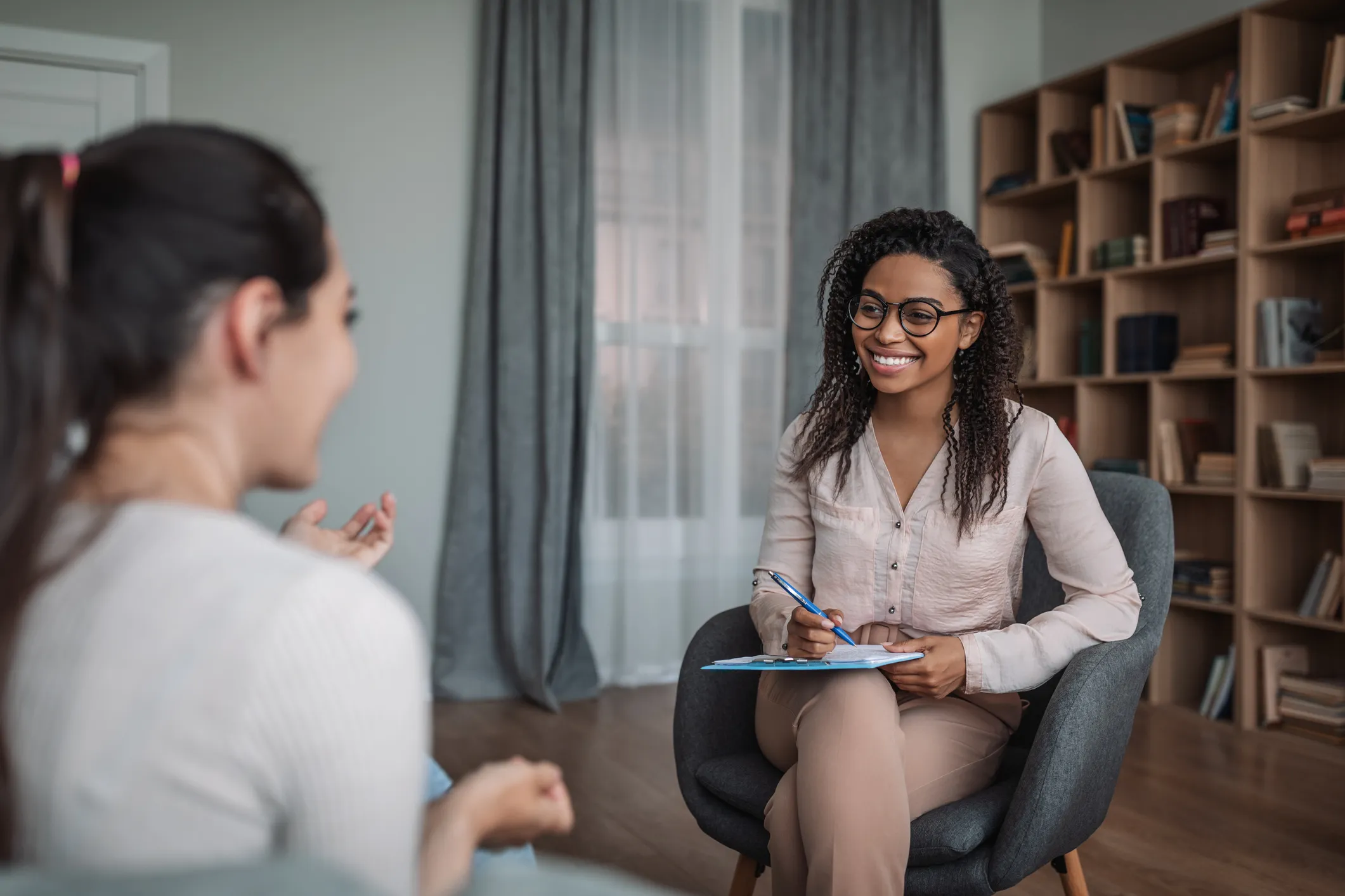 Counselor listening to client in office