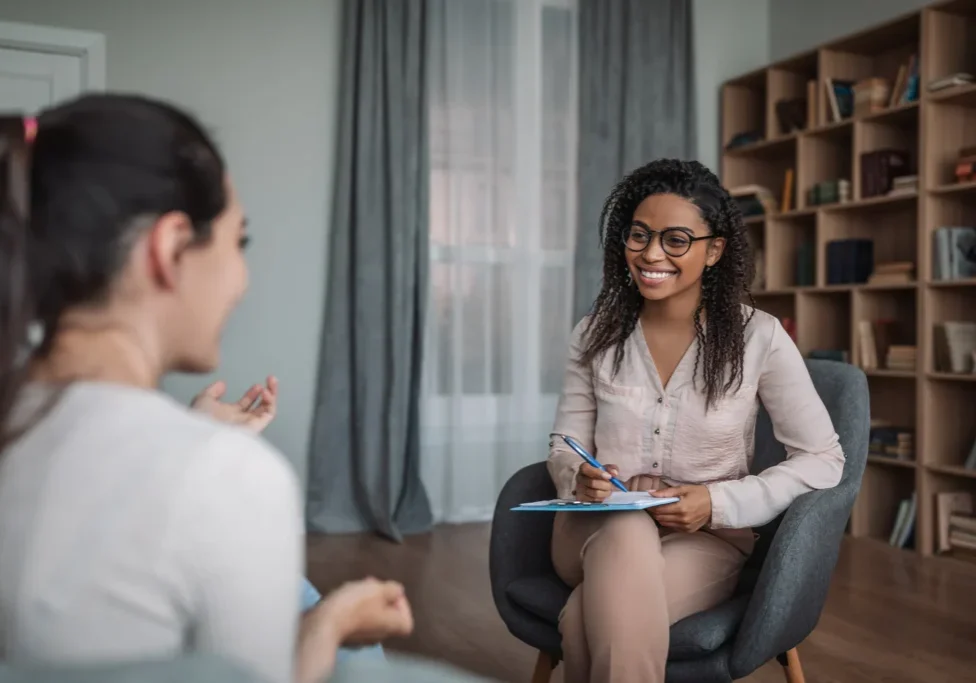 Counselor listening to client in office
